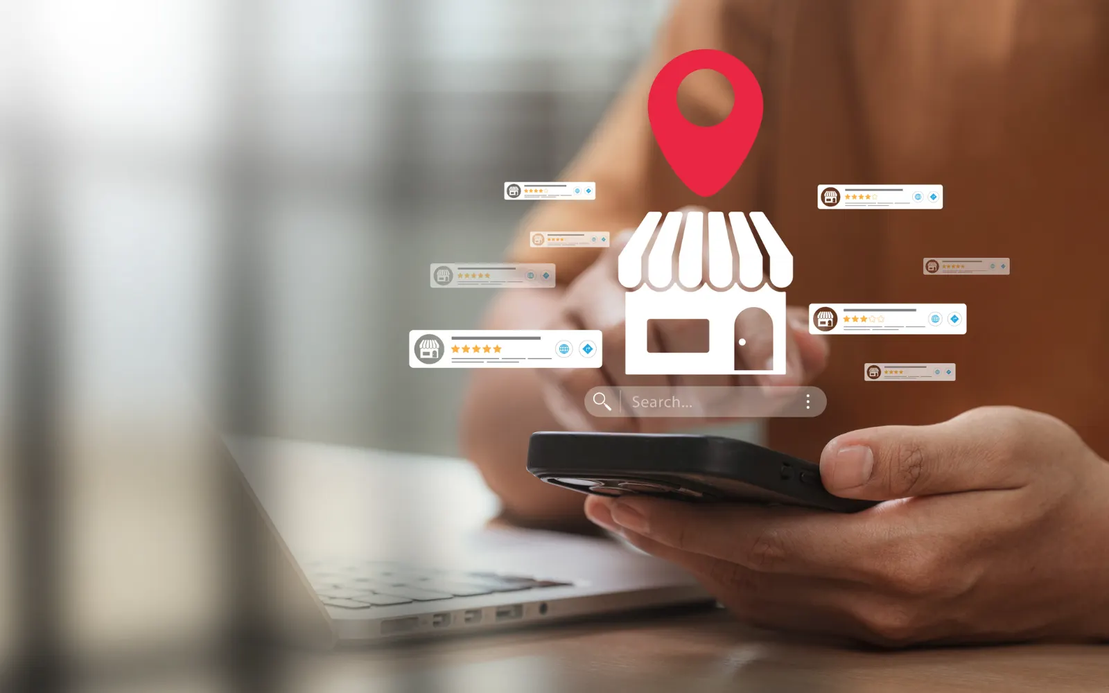 Hand holding a smartphone with a storefront location pin and review icons